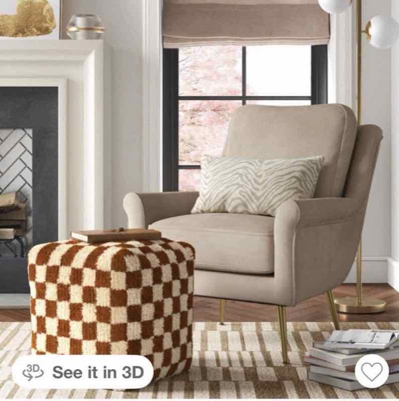 Tan upholstered accent chair styled in a living room