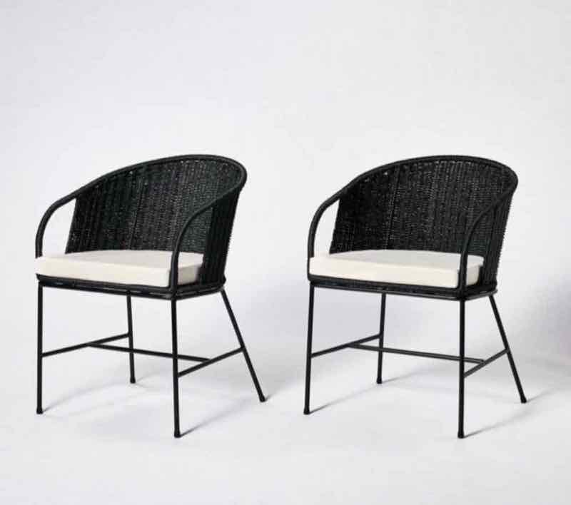 Pair of black woven barrel dining chairs with cushions
