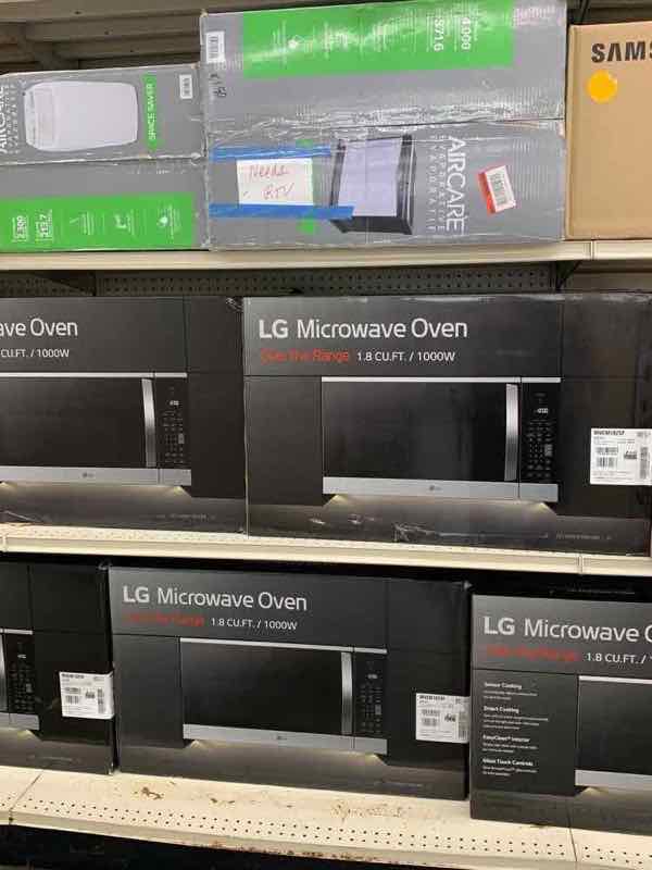 LG over-the-range microwave ovens in shelf display