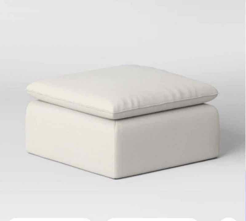 Cream upholstered cube ottoman with plush cushioned top