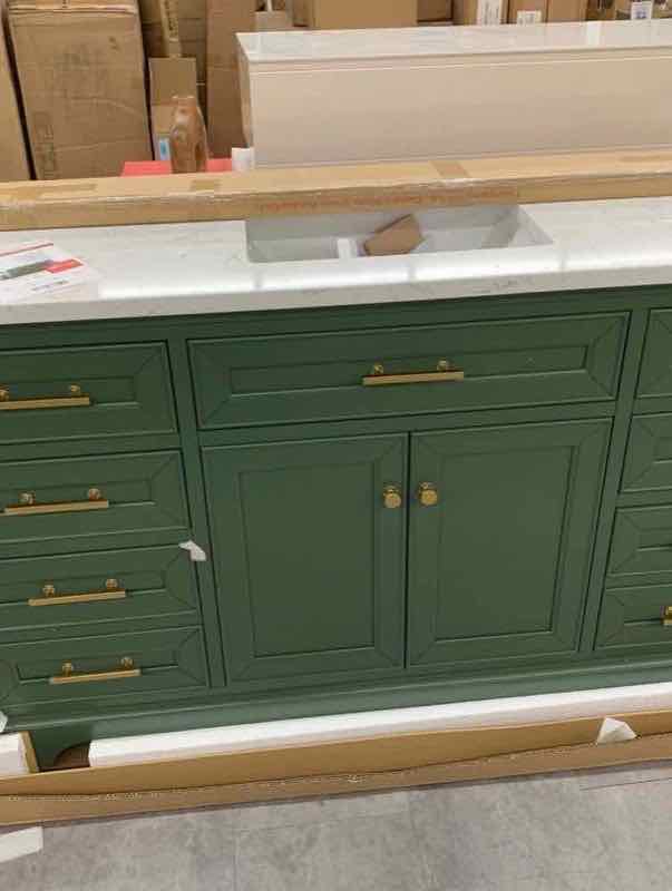 Green bathroom vanity with white quartz top and gold hardware