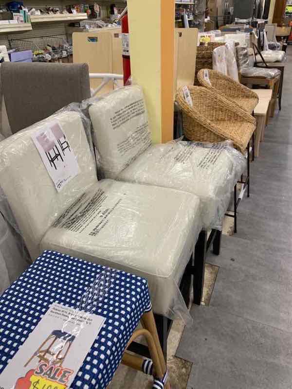 Set of dining chairs still in plastic wrap